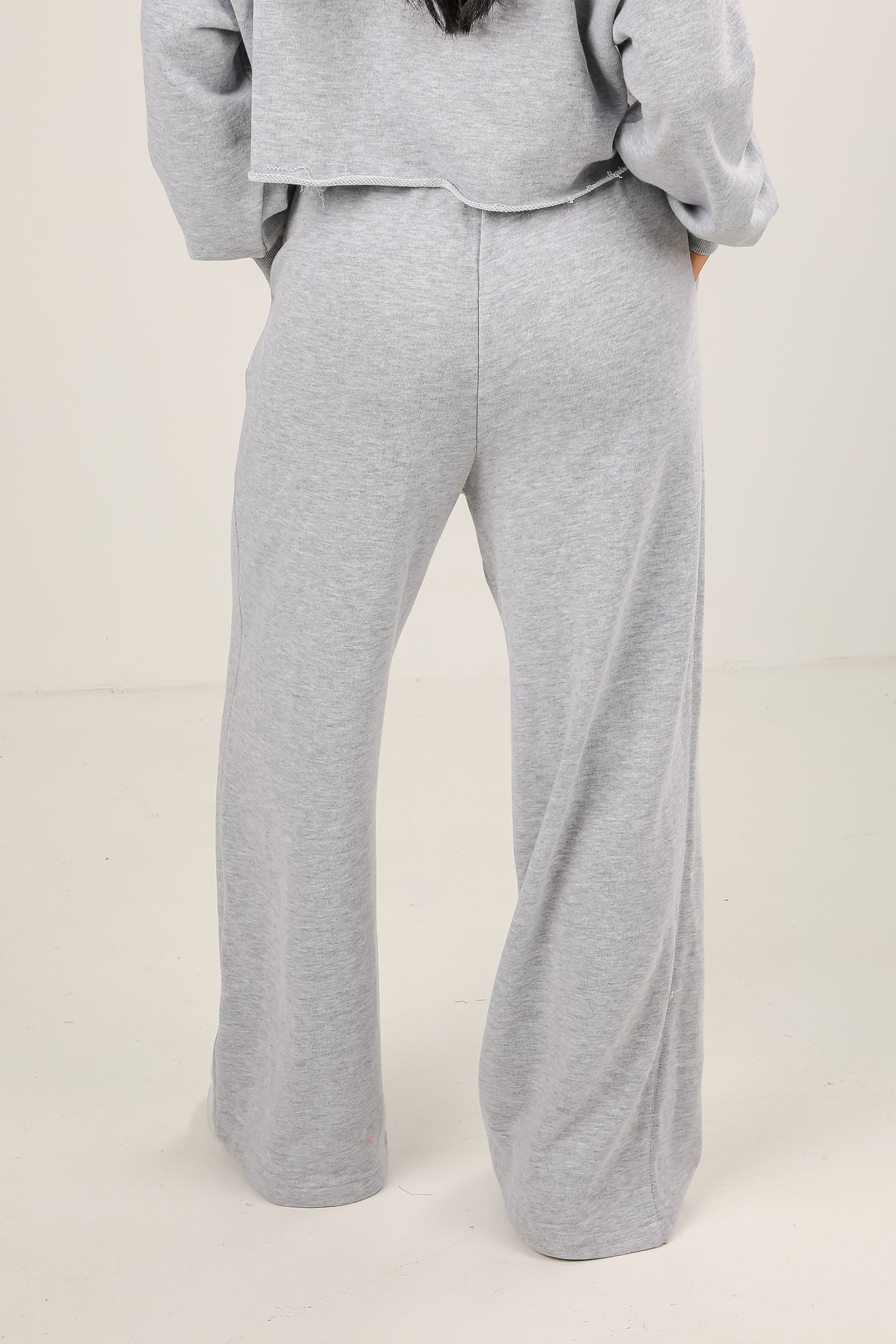 Gray sweatshirt and pants set on a plain background