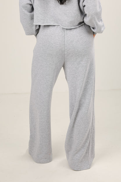 Gray sweatshirt and pants set on a plain background