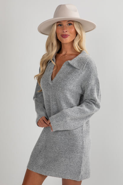 Woman wearing a gray dress and beige hat on a white background