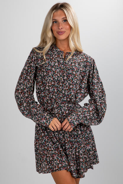 Woman wearing a floral dress against a plain background