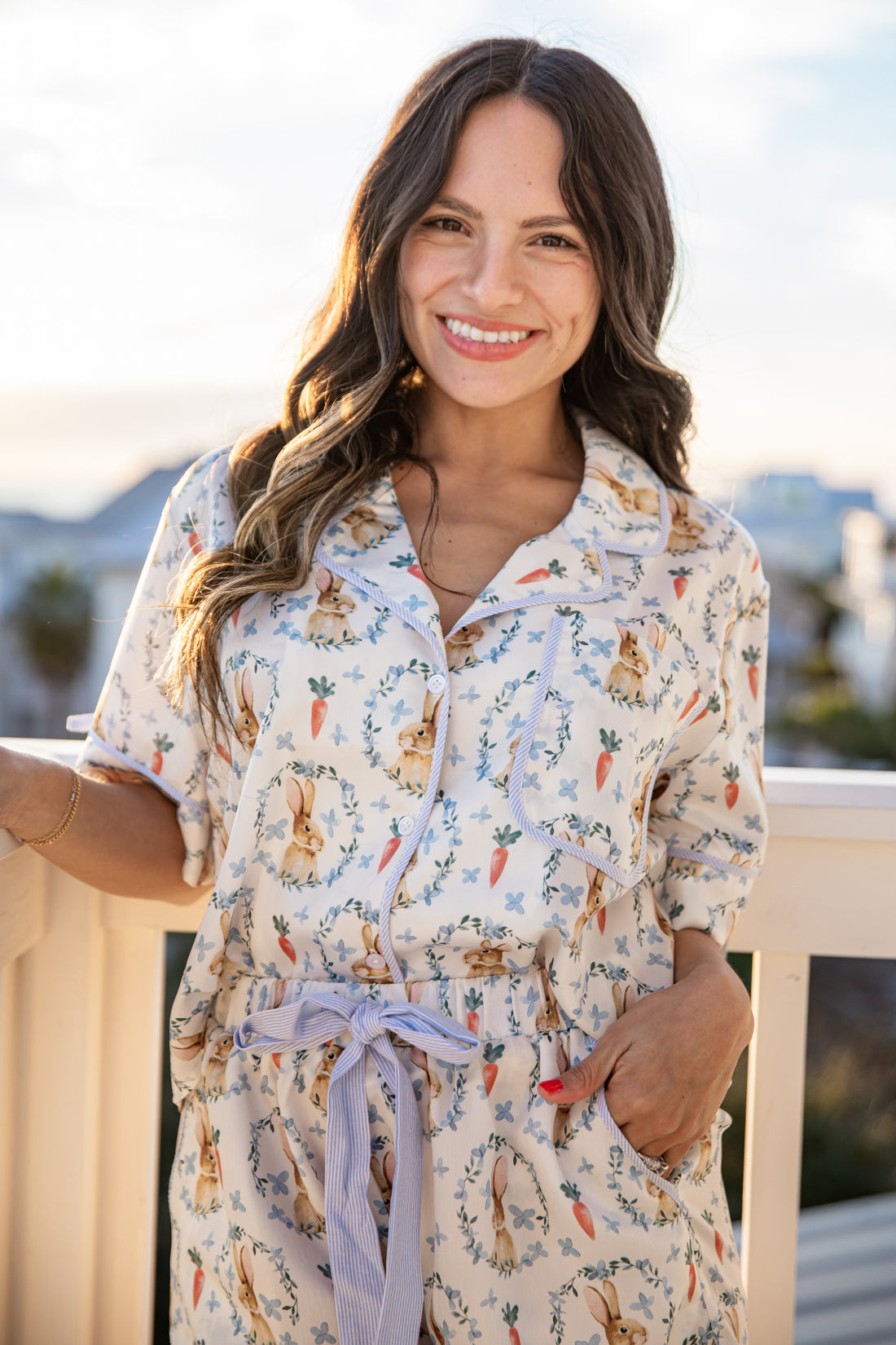 Woman wearing a patterned dress with a scenic background