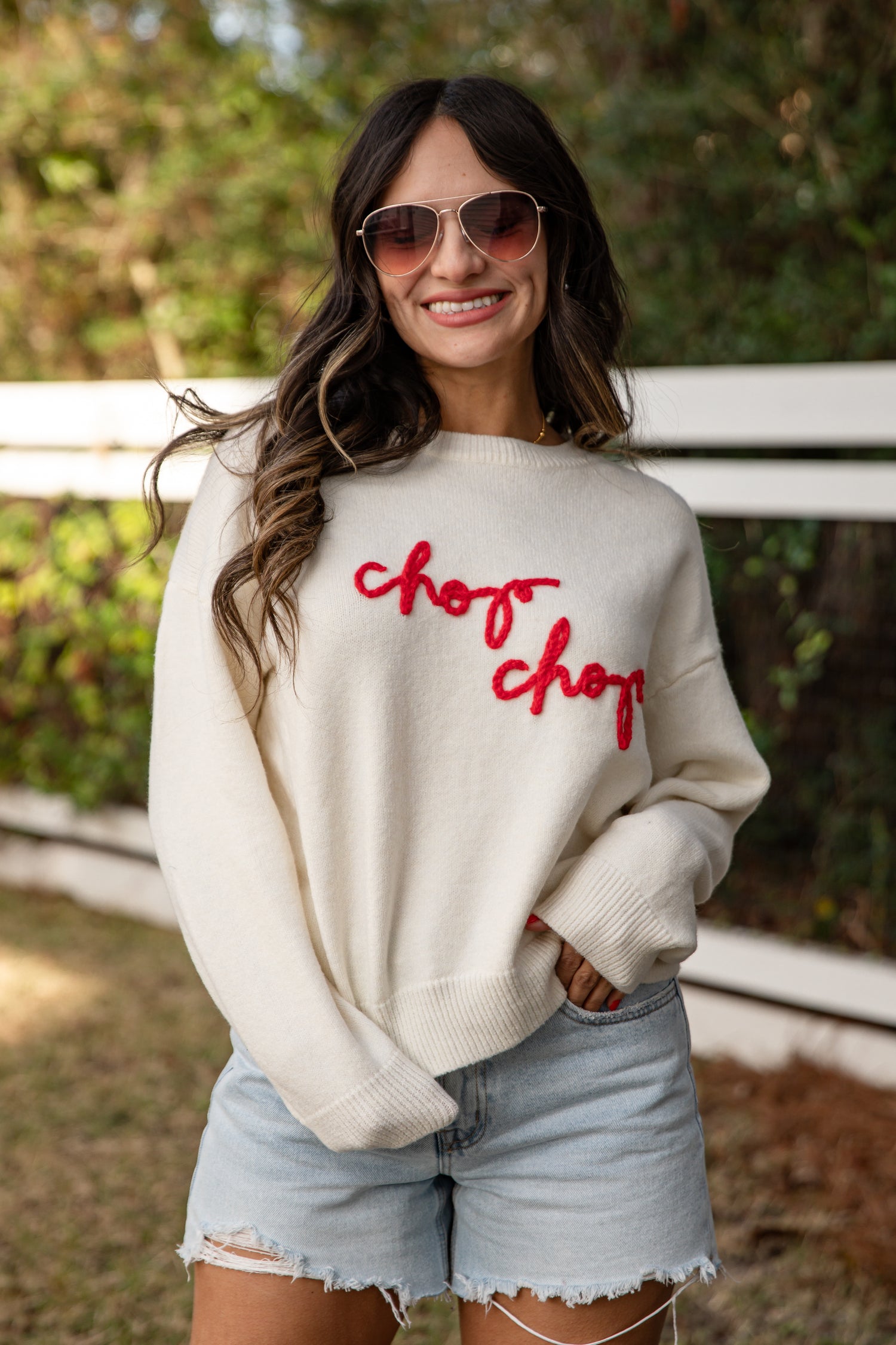 Woman wearing a white sweatshirt with &