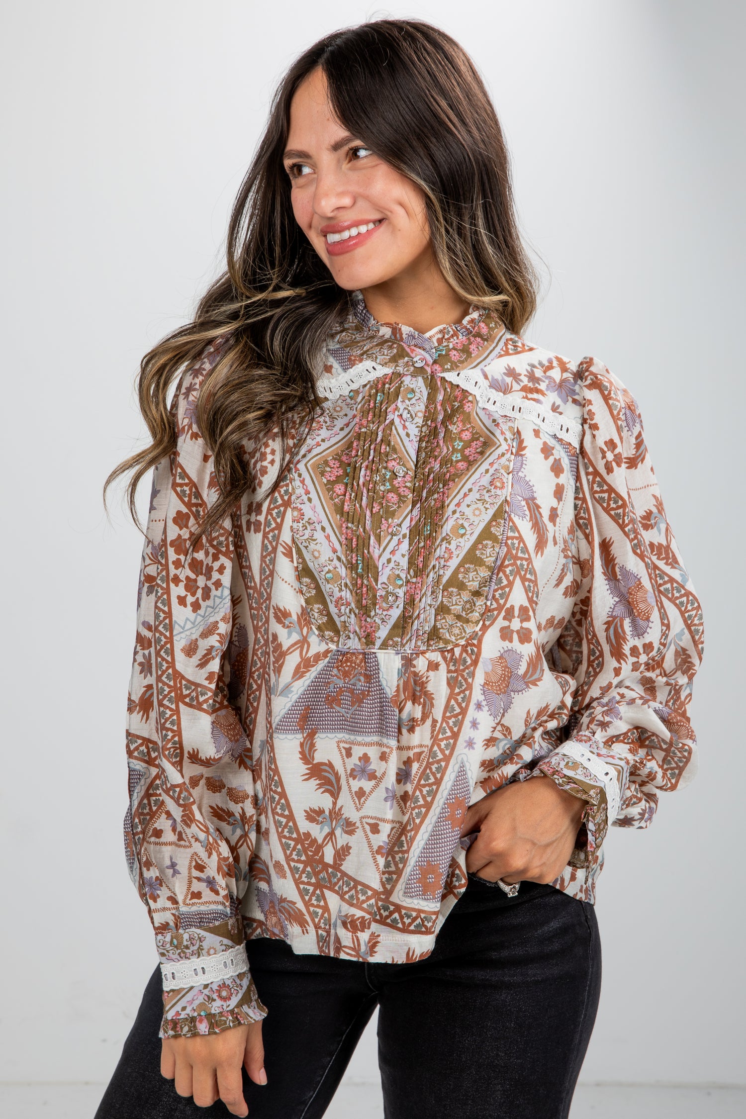 Woman wearing a patterned blouse with a plain background