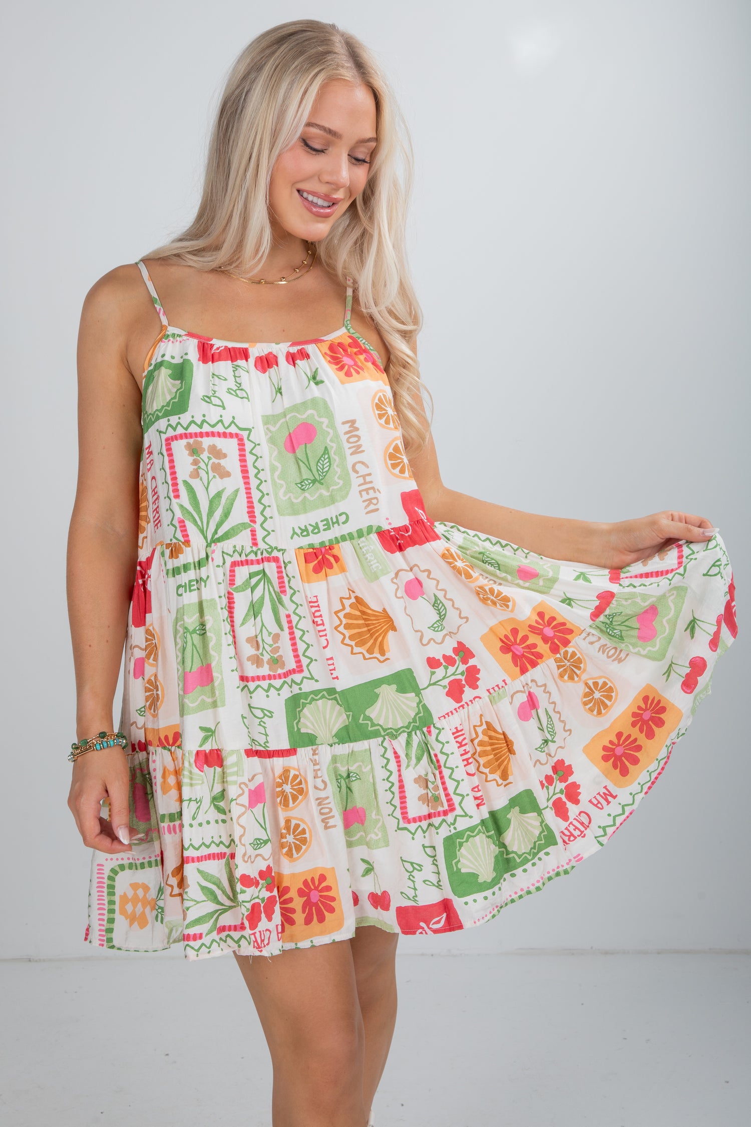 Woman wearing a colorful patterned dress against a white background