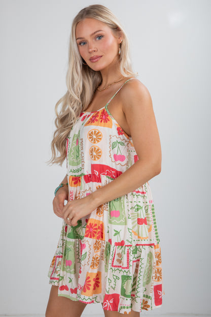 Woman wearing a colorful patterned dress against a white background