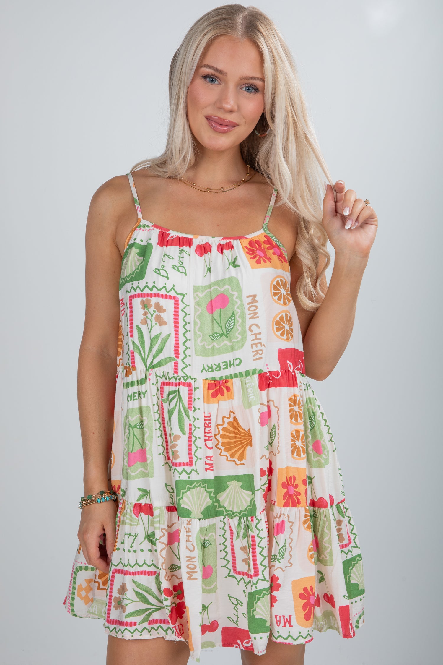 Woman wearing a colorful dress with a pattern on a plain background