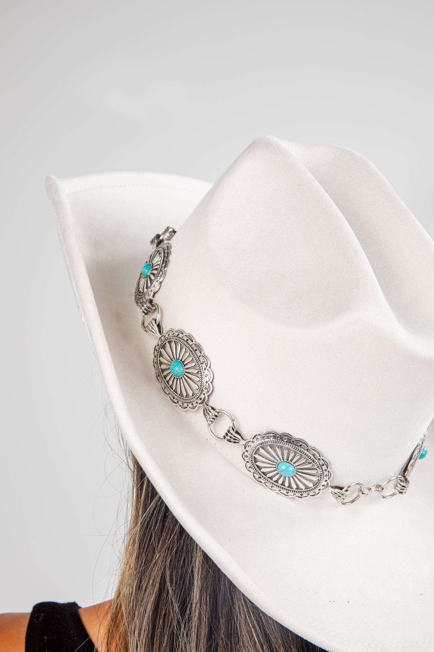 Silver bracelet with turquoise stones on a white hat