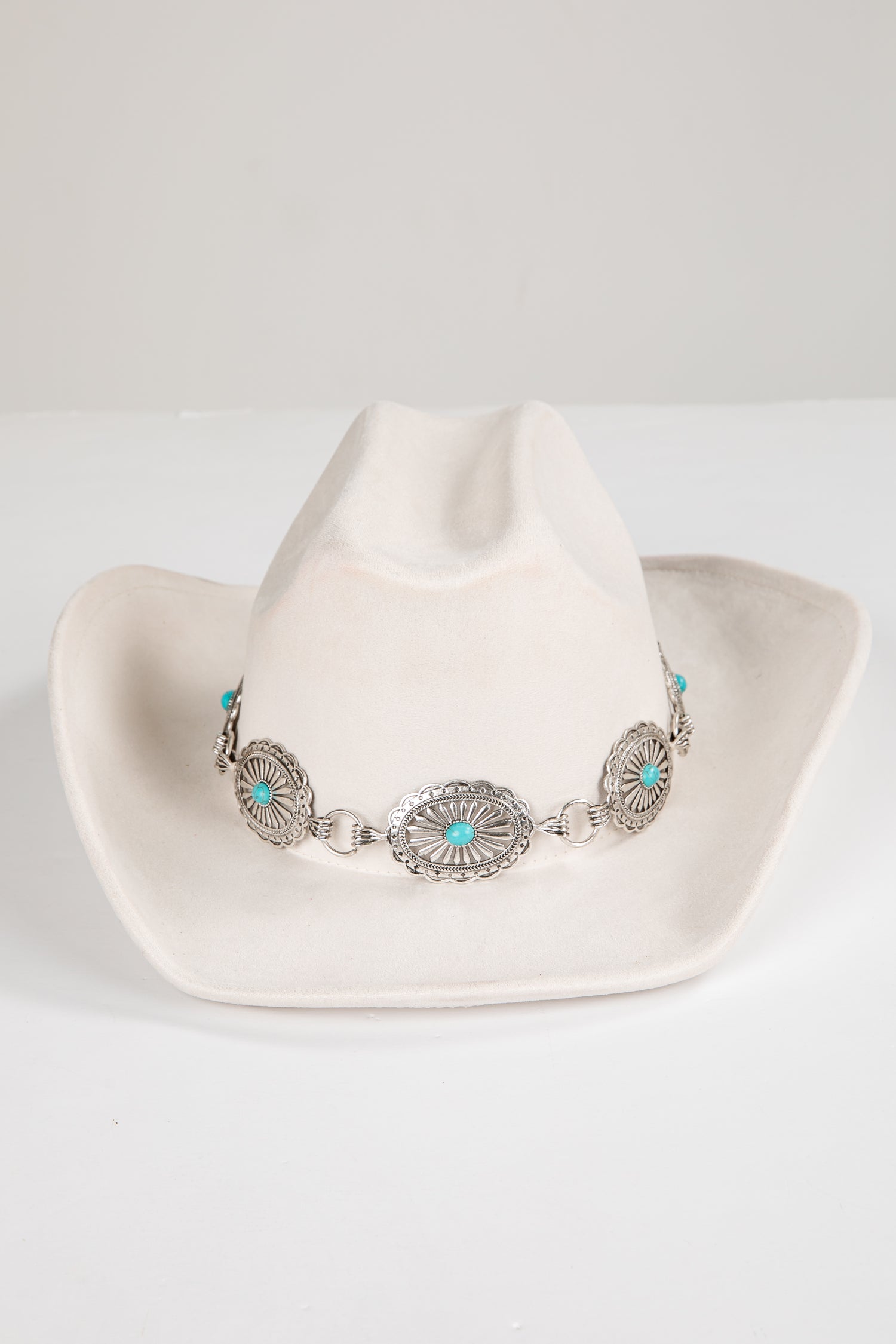 White cowboy hat with a decorative band featuring turquoise stones on a white background