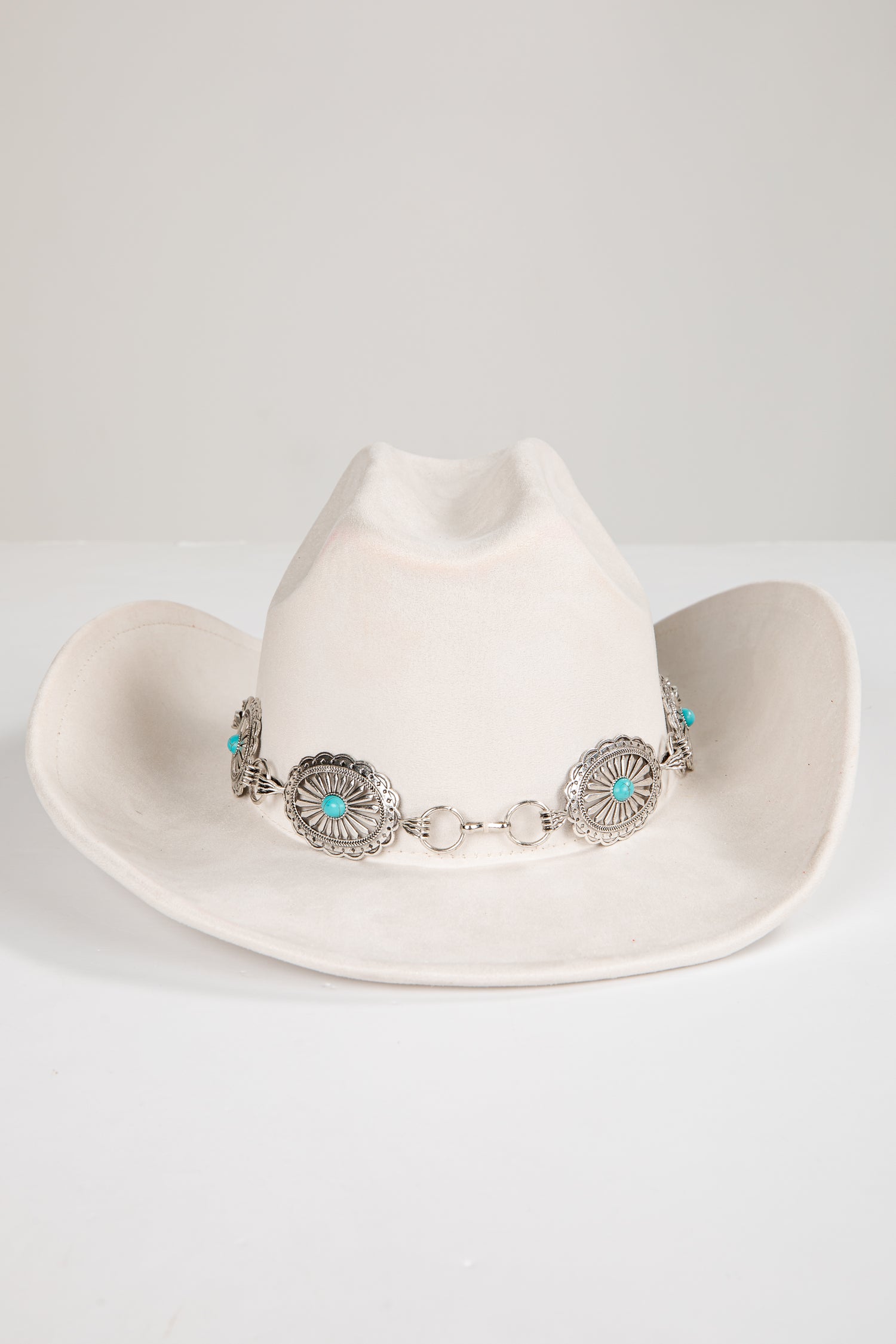 White cowboy hat with decorative band on a white background