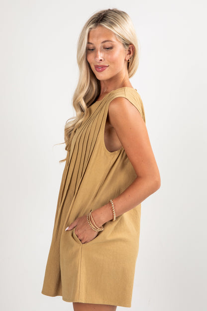 Woman wearing a beige dress on a white background