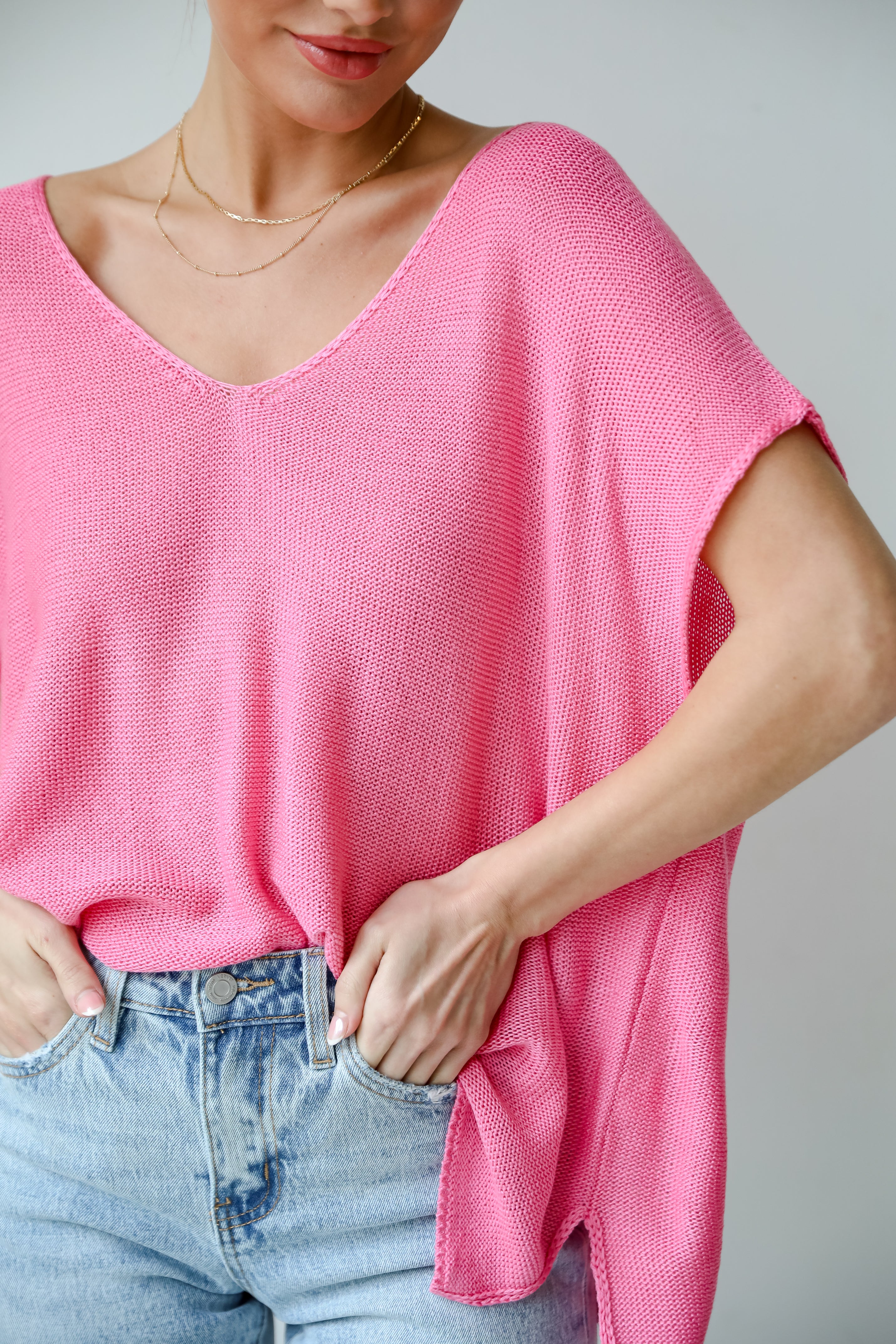 Eliza Lightweight Knit Top is the perfect spring sweater. Lightweight knit sweater, with v-neck, short sleeves, and oversized fit. Pairs well with denim. Online boutique. 