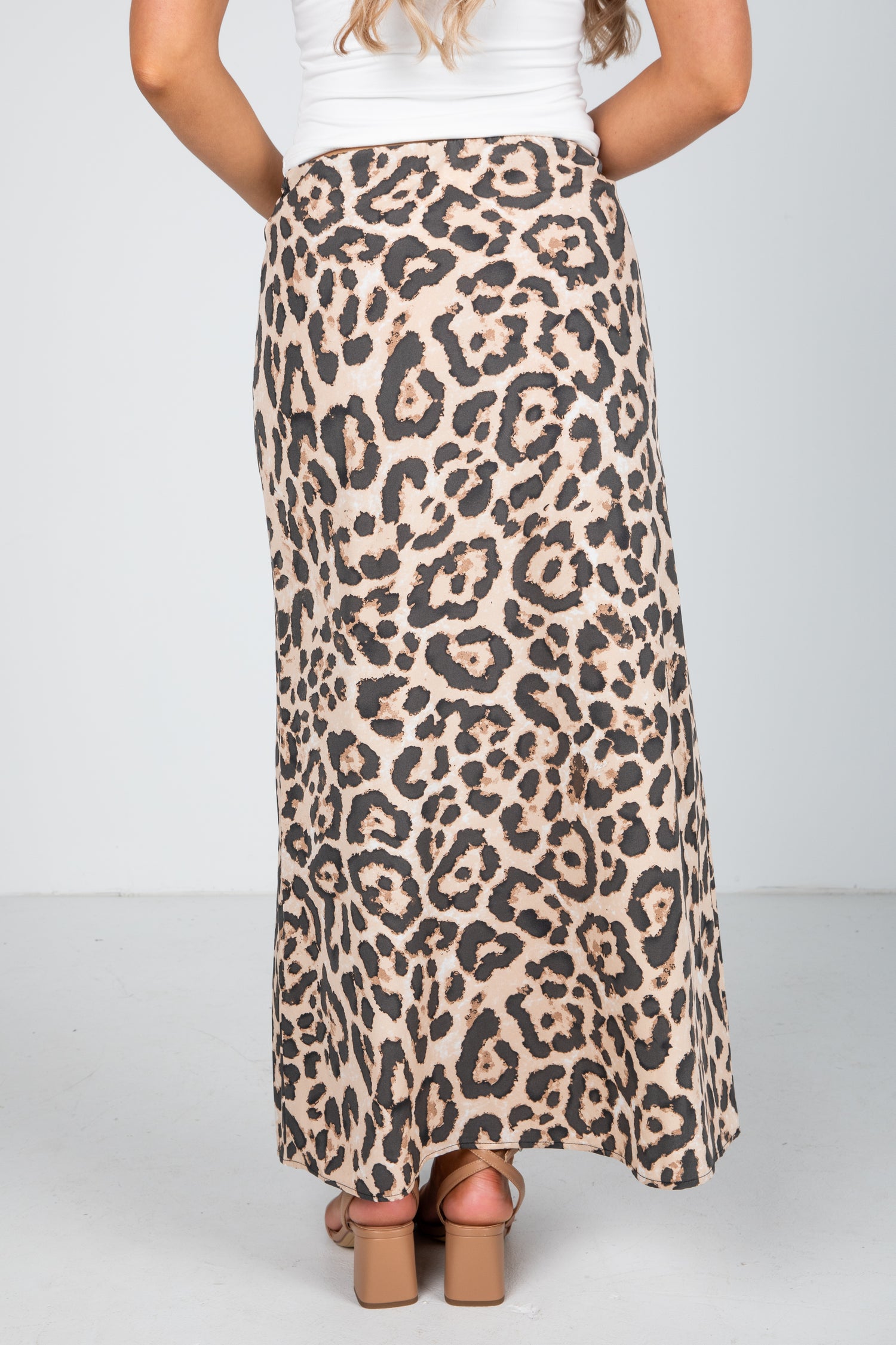 Leopard print skirt worn by a person on a plain background