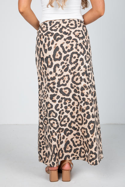 Leopard print skirt worn by a person on a plain background