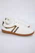 White sneaker with brown sole and leopard print accents on a light gray background