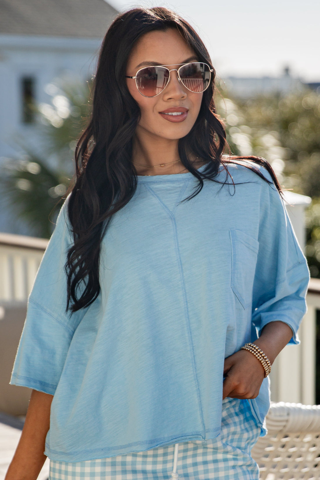 woman wearing a blue casual basic top with front pocket