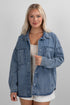 Woman wearing a denim jacket on a gray background
