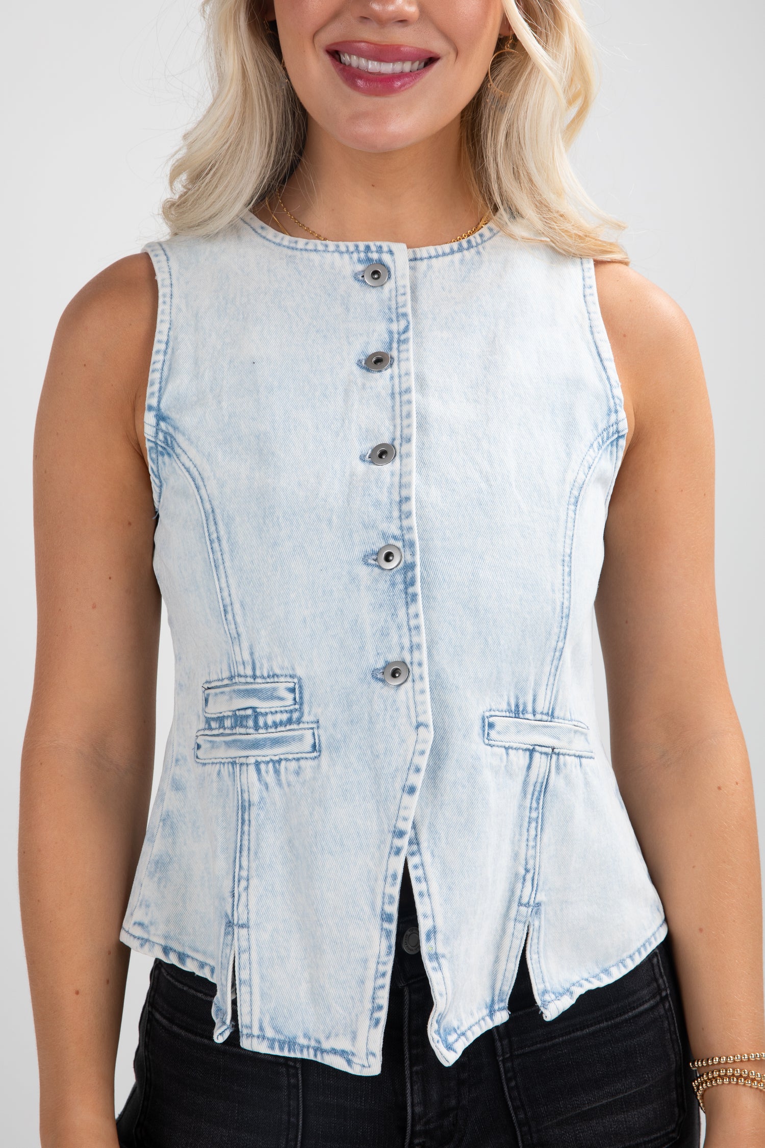 Light blue denim sleeveless top worn by a person on a white background