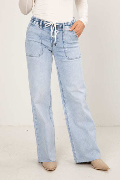Light blue jeans worn by a person on a white background