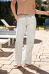 Person wearing light-colored pants and a sleeveless top on a patio