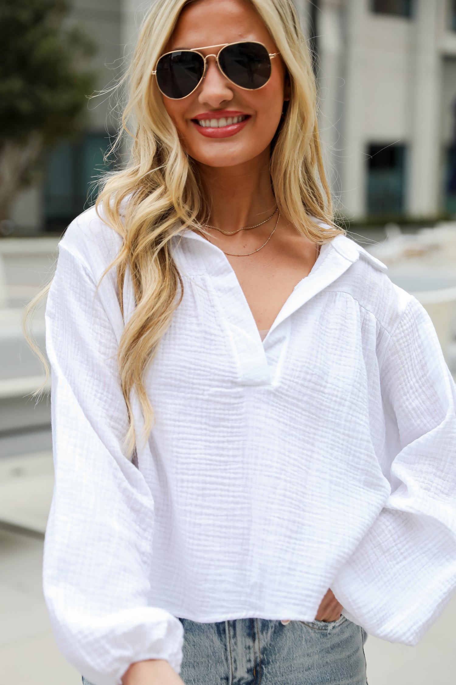 Alanna Linen Blouse is a Lightweight Crinkle Linen top, with a Collared V-Neckline, Long Balloon Sleeves with Elastic Cuffs. Relaxed Fit, 100% Cotton, and the perfect shade of blue and white. boutique tops. Women tops for summer. 