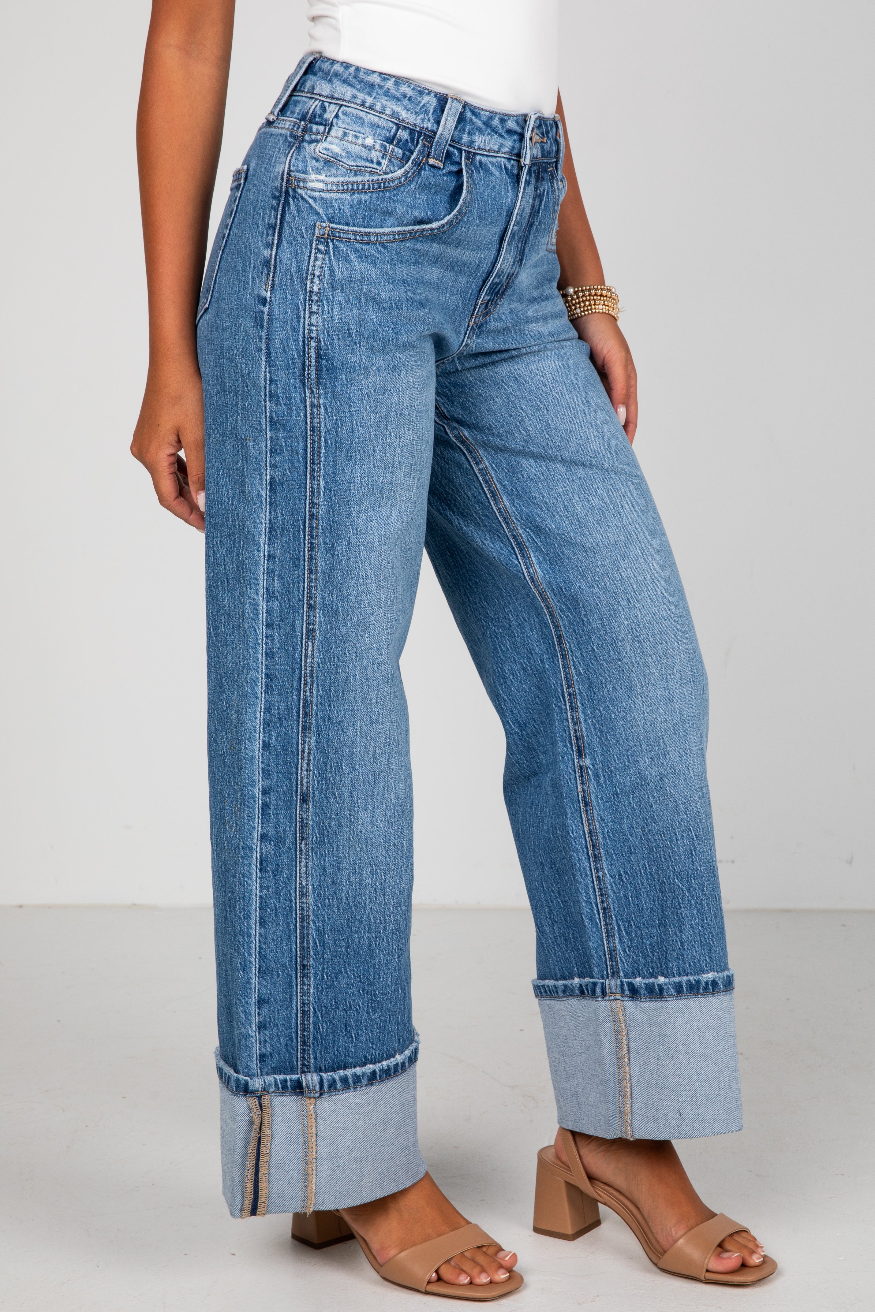 Person wearing blue jeans with a white background