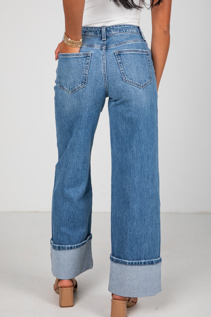 Person wearing blue jeans with a white background