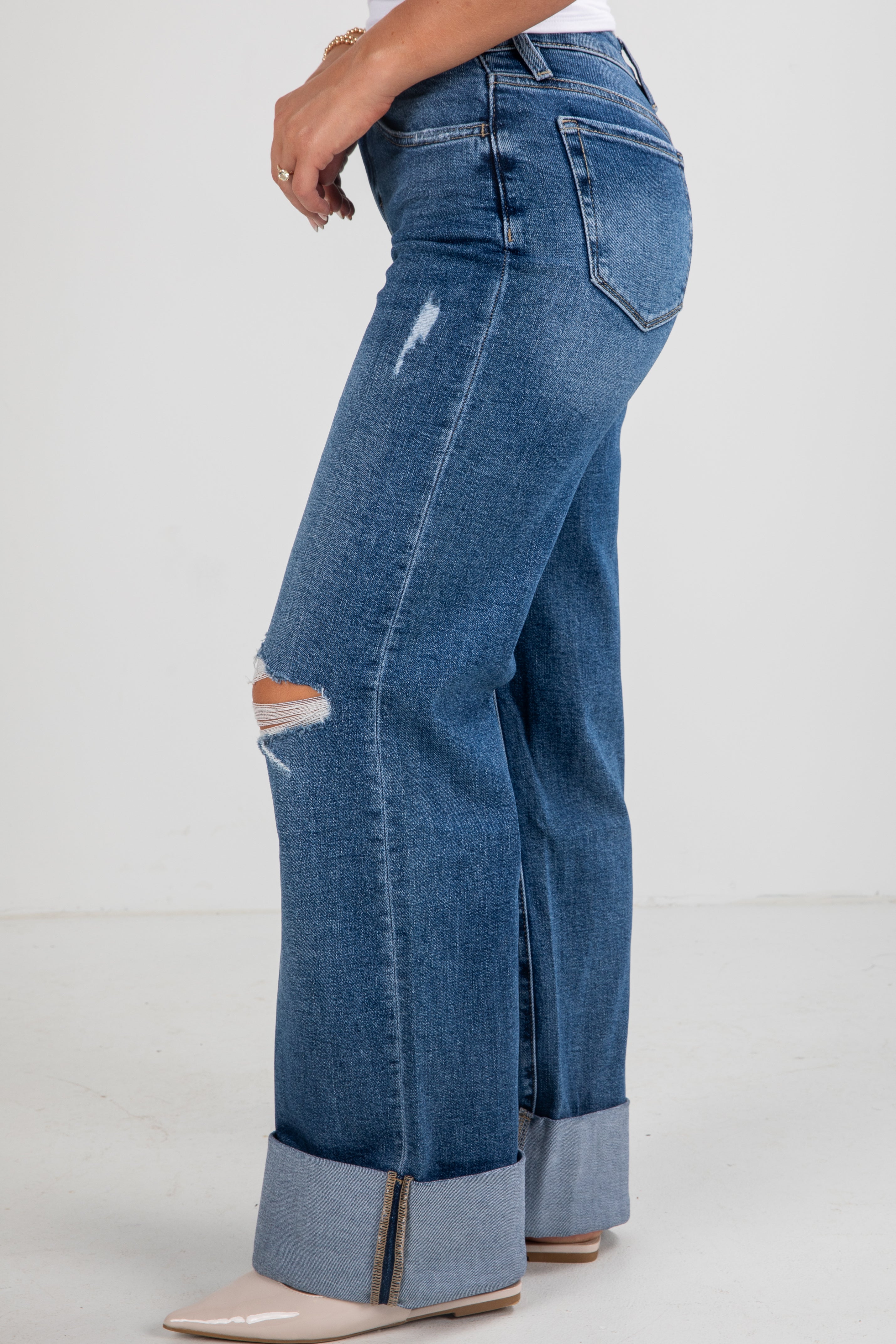 Blue jeans with a distressed design on a white background