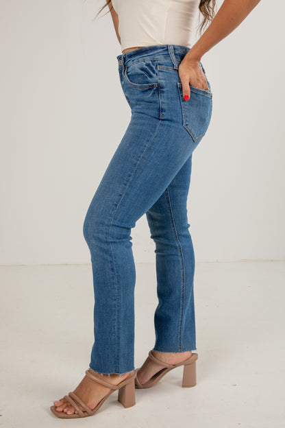 Blue jeans worn by a person on a white background