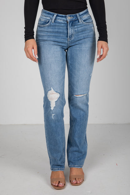 Blue jeans with slight distressing on a plain background