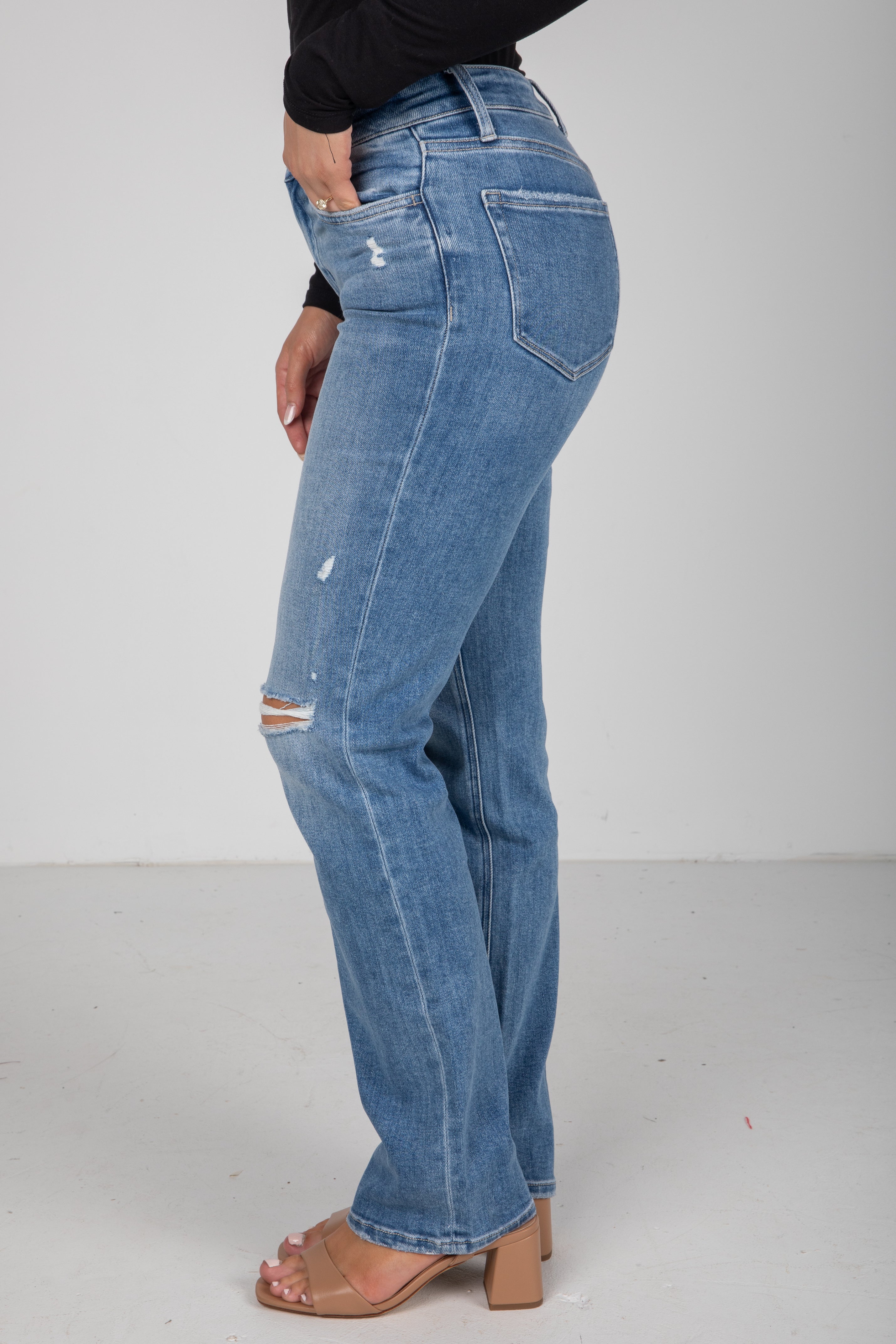 Blue jeans with slight distressing on a plain background