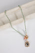 Necklace with gemstone pendant on a marble surface