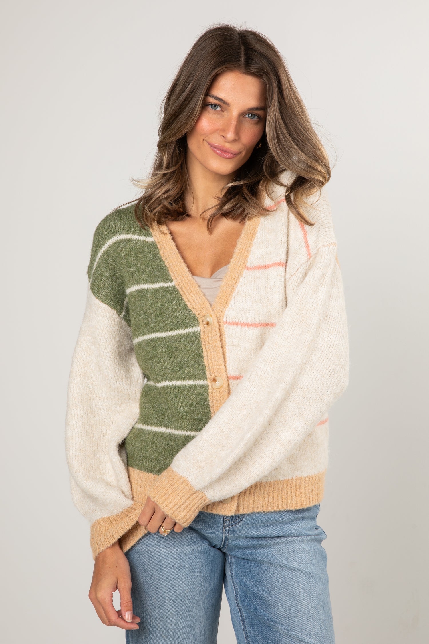 Woman wearing a colorful cardigan with a neutral background