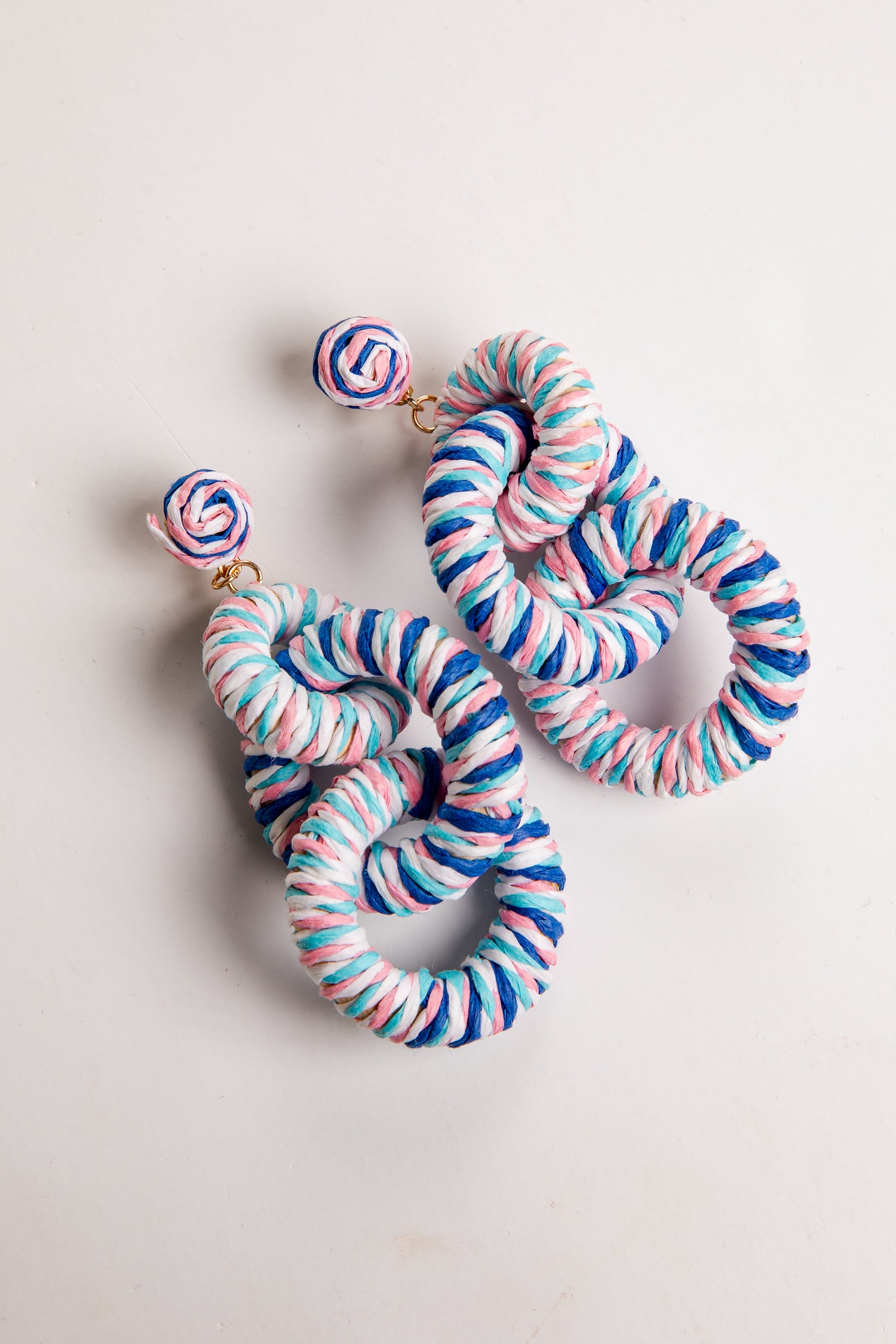 Set of colorful scrunchies and earrings on a light background