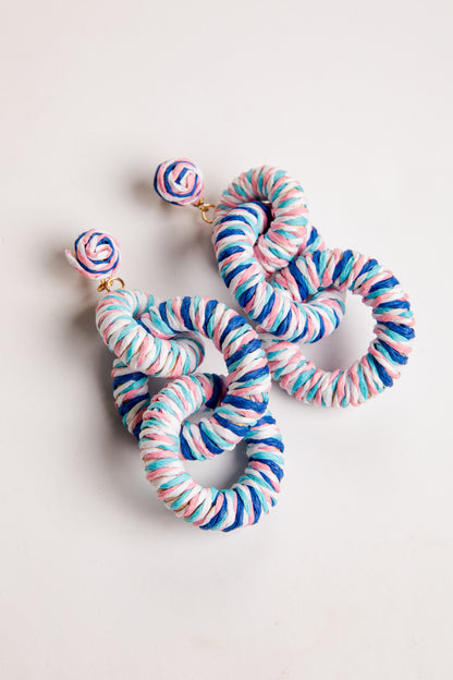 Colorful striped earrings on a light background