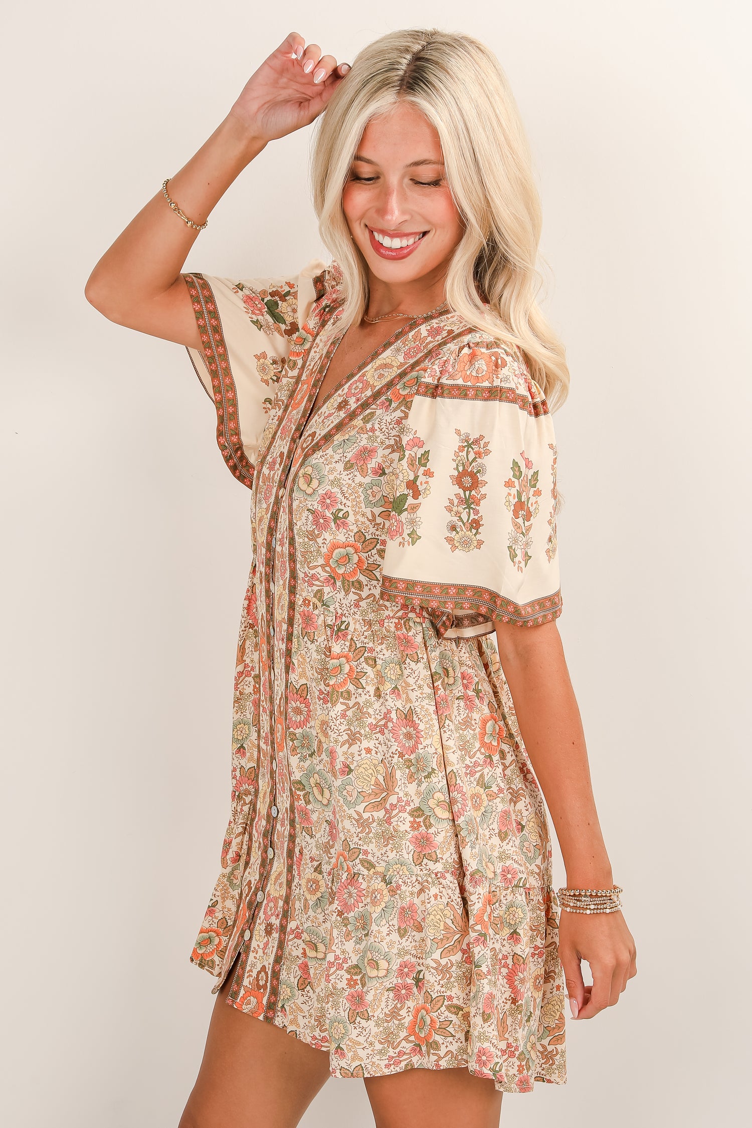 Woman wearing a floral dress with a plain background