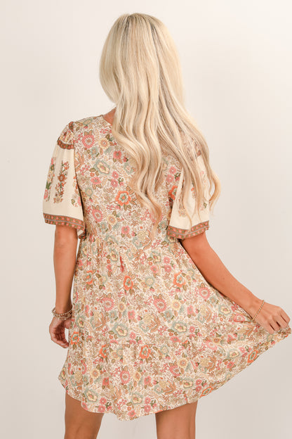 Woman wearing a floral dress with a plain background