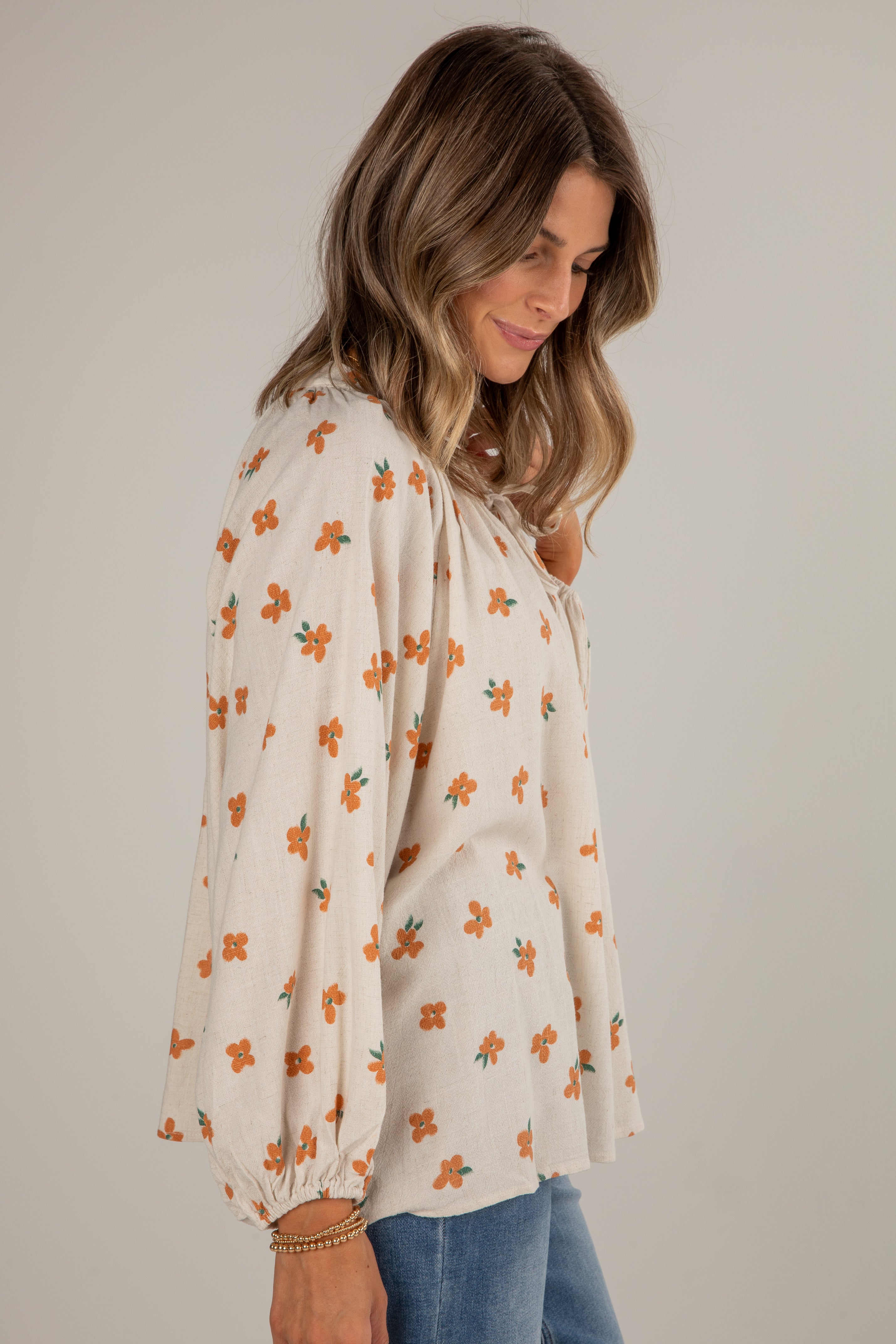 Woman wearing a floral blouse with a plain background