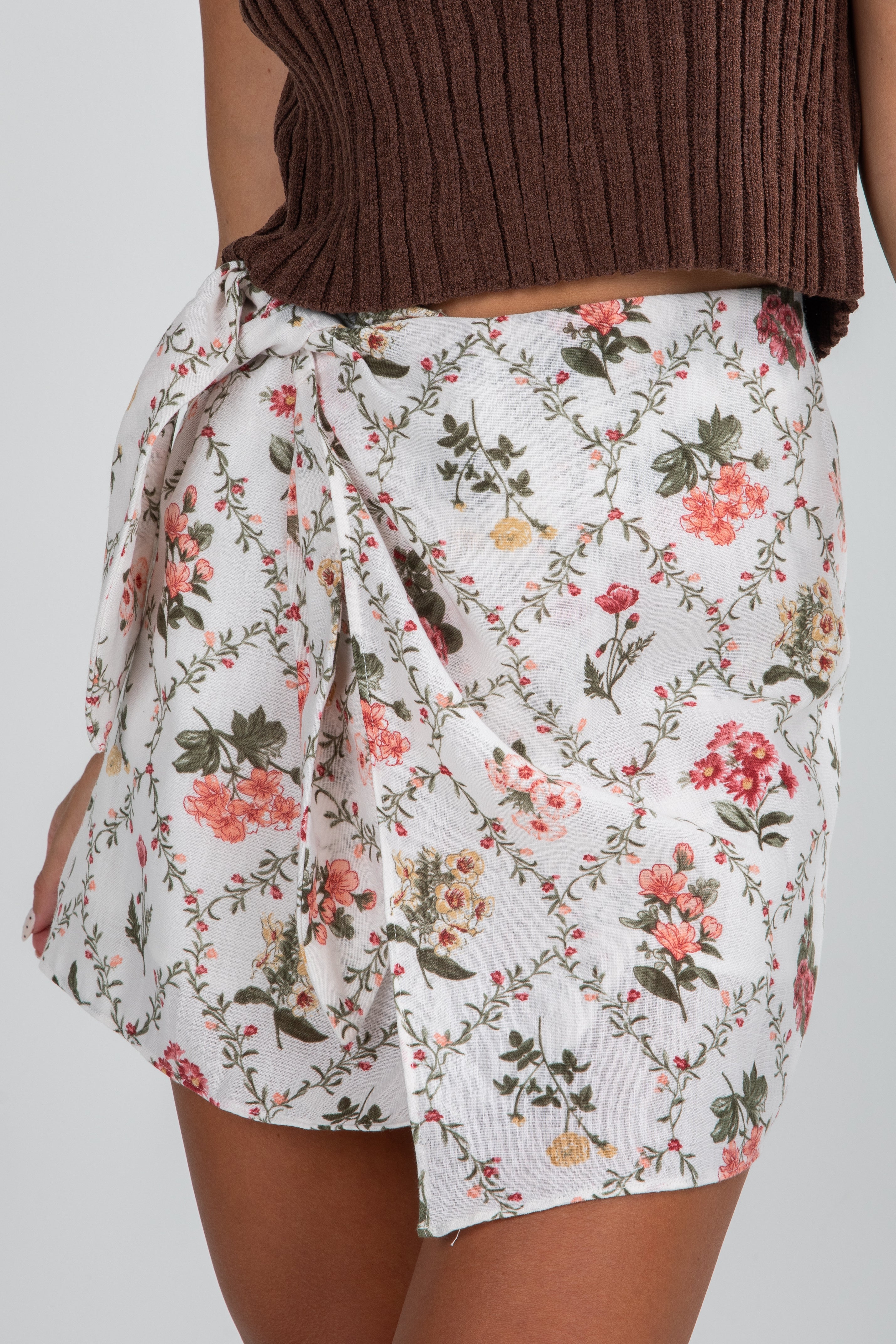 Floral wrap skirt on a plain background