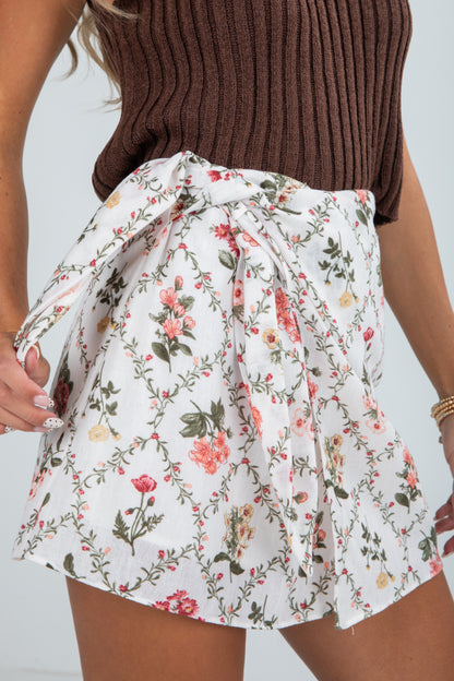 Floral skirt worn by a person with a plain background