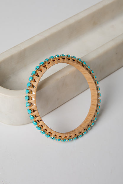 Wooden bracelet with turquoise beads on a light background