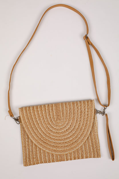 Woven handbag with a brown strap on a white background