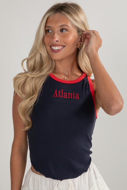 Woman wearing a navy tank top with &