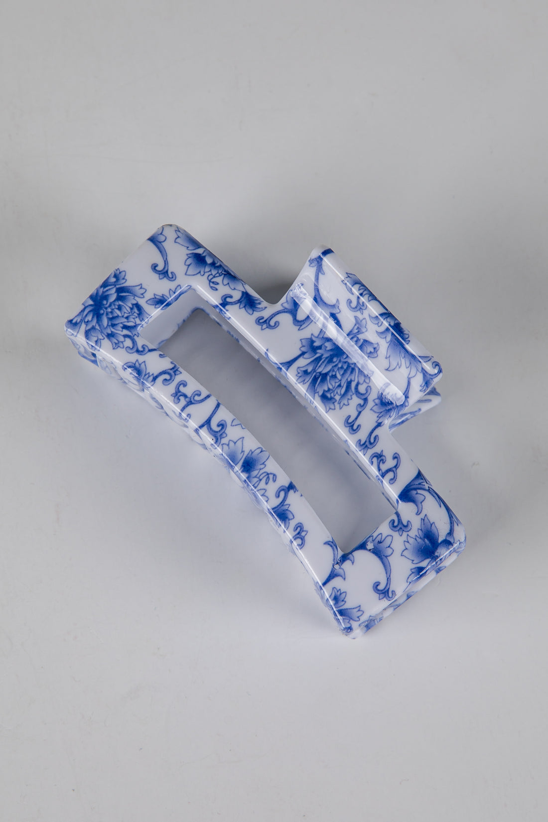 Blue and white decorative item on a gray background