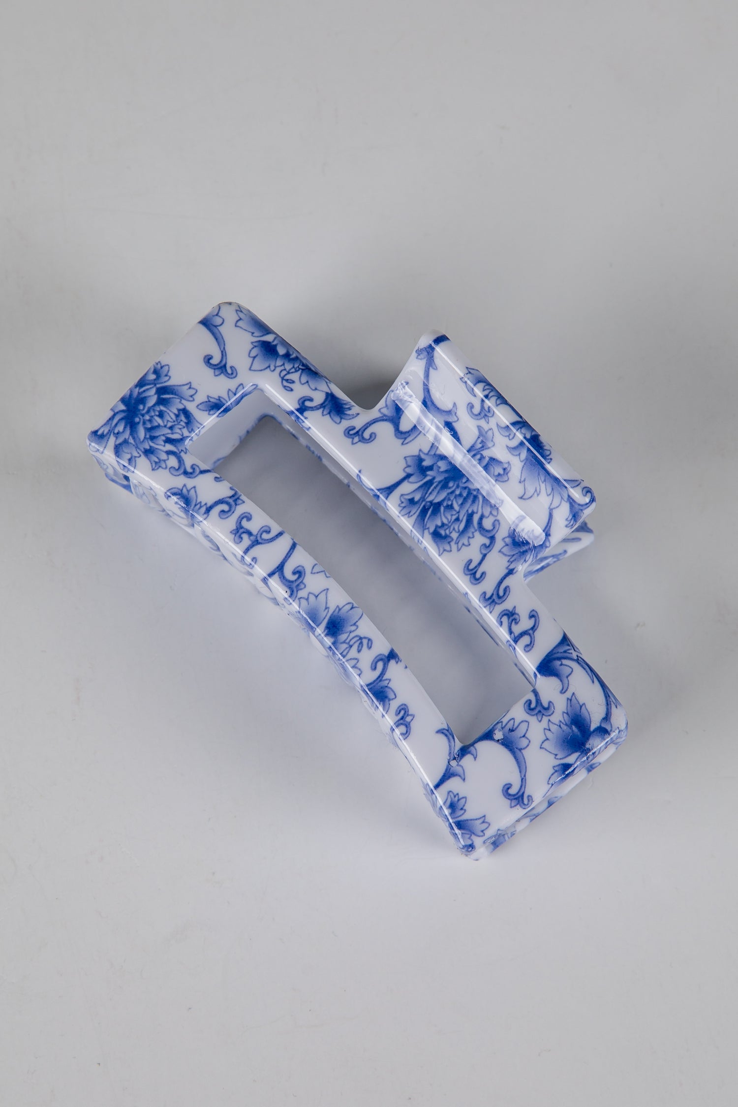 Blue and white decorative item on a gray background