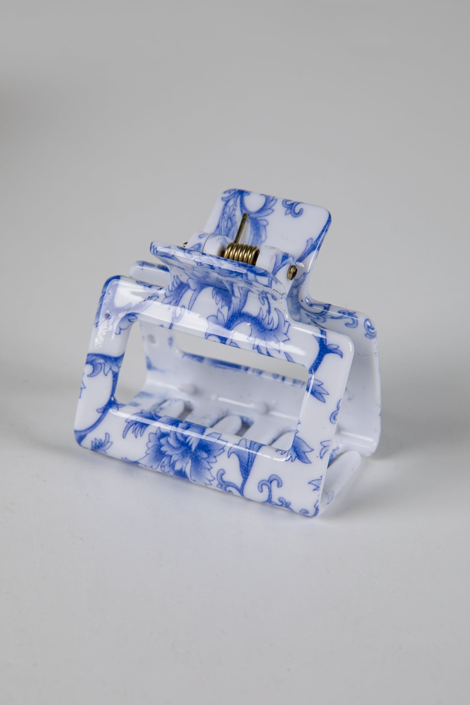 Clear pouch with blue floral pattern on a gray background