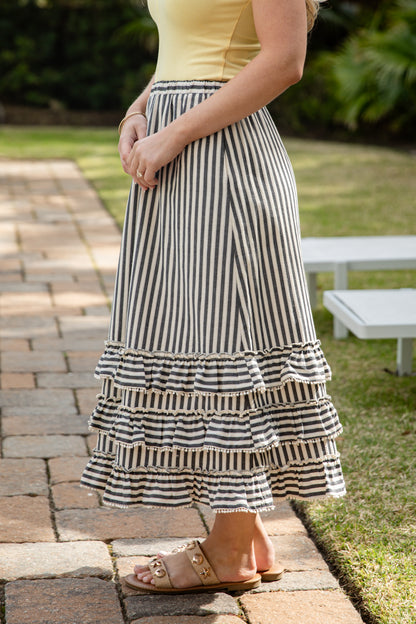 Woman wearing striped maxi skirt. 