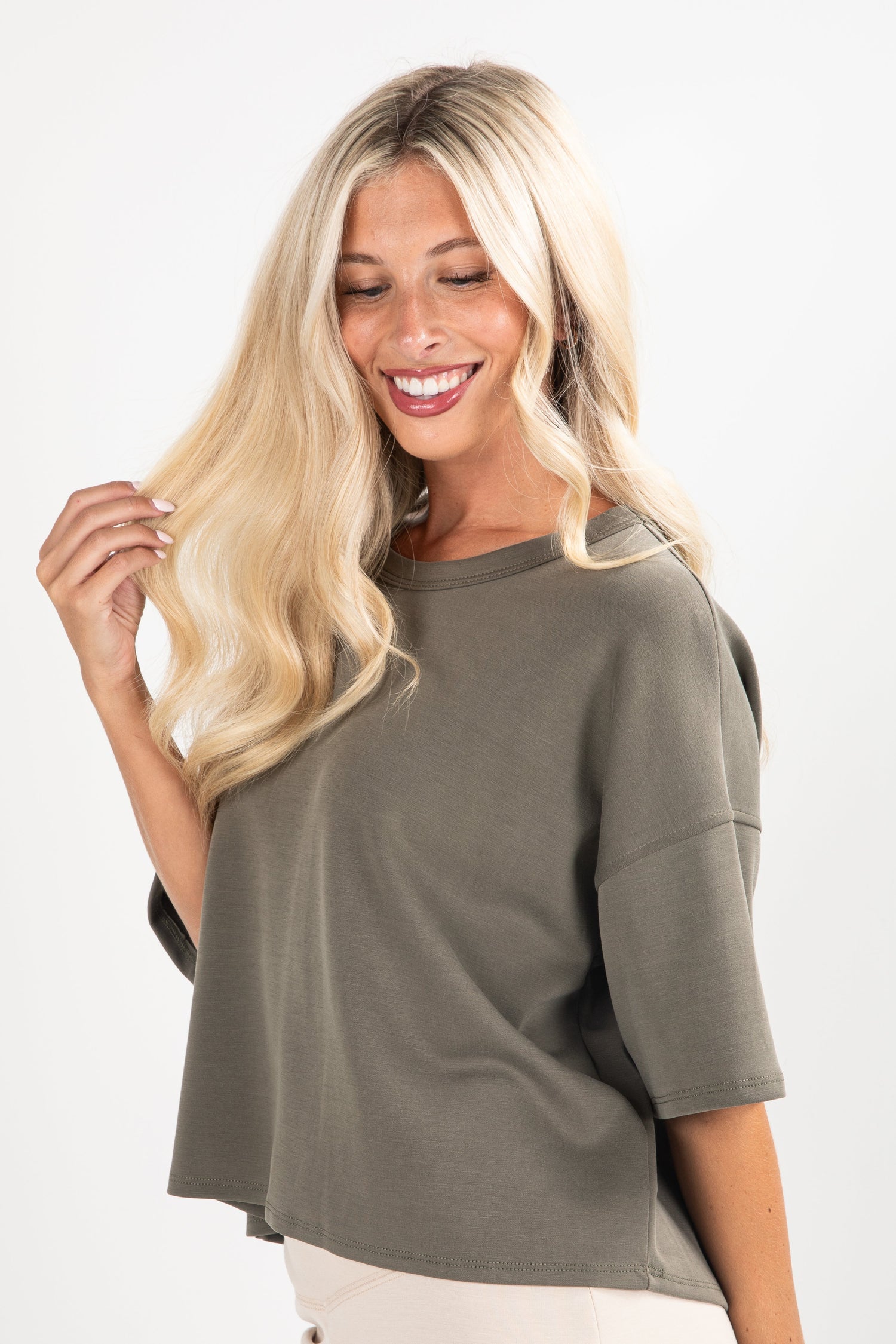 Woman wearing a green oversized shirt on a white background