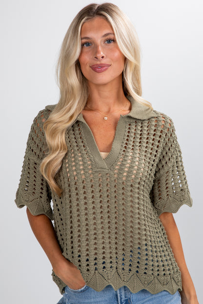 Woman wearing a green crochet top against a plain background