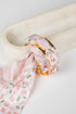 Pink floral bracelet on a marble surface