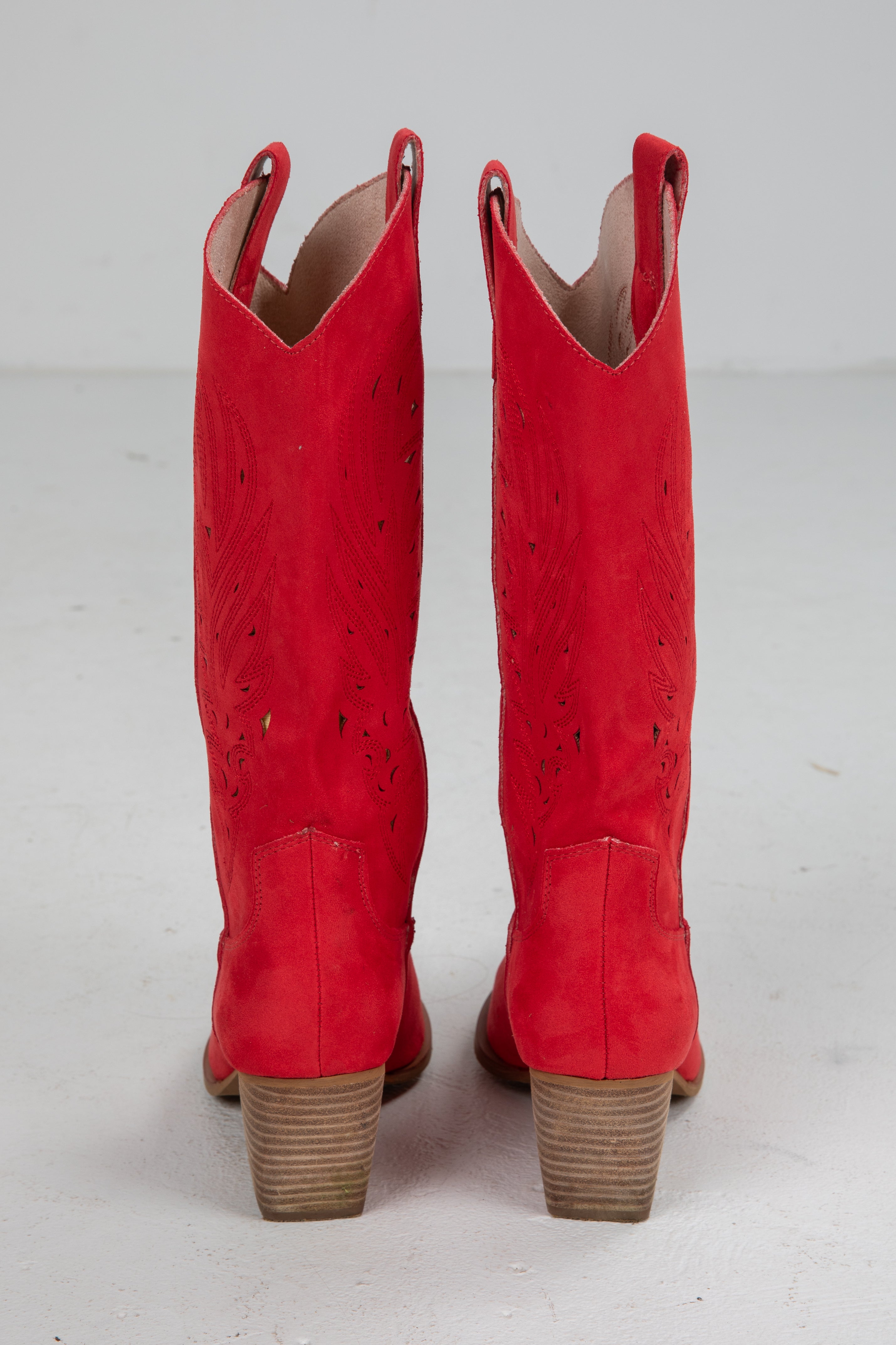 Pair of red cowboy boots on a white background